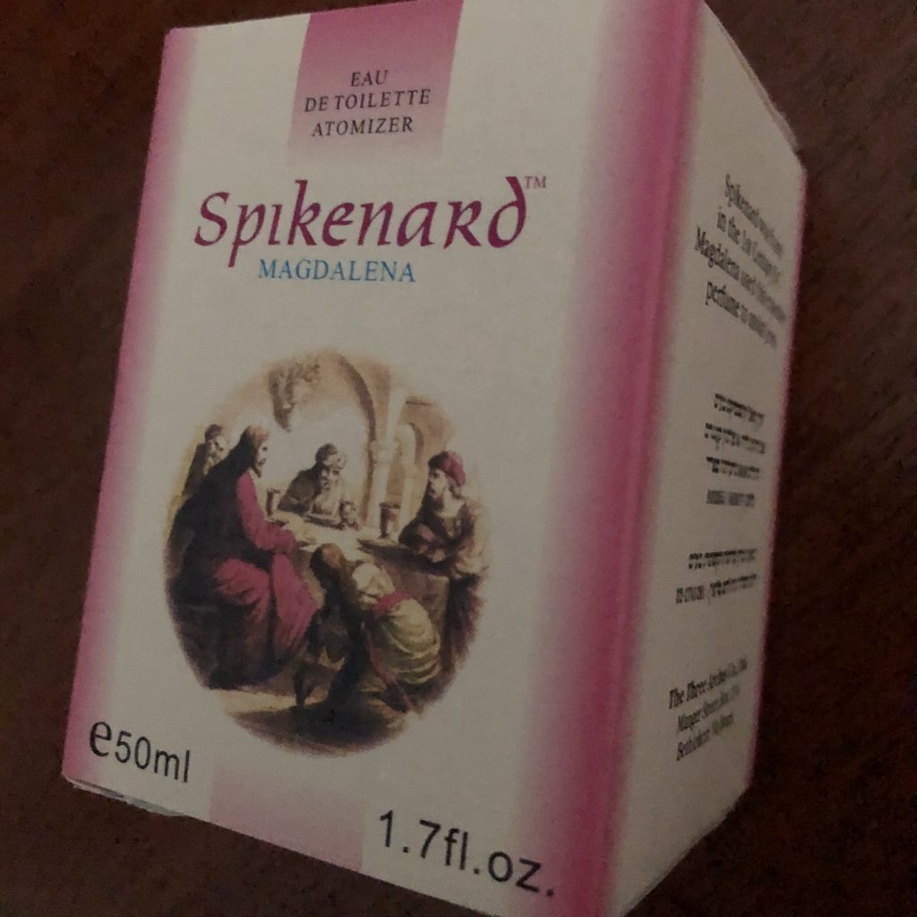 The box filled with a bottle of Spikenard perfume covered by the Scriptures about Mary and Martha.