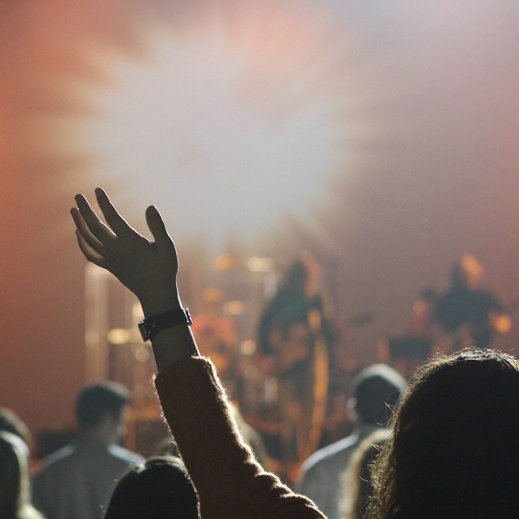 Need God-a worshipper surrendering to God with her hand raised.